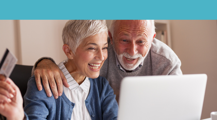 People with gray hair looking at a computer screen.