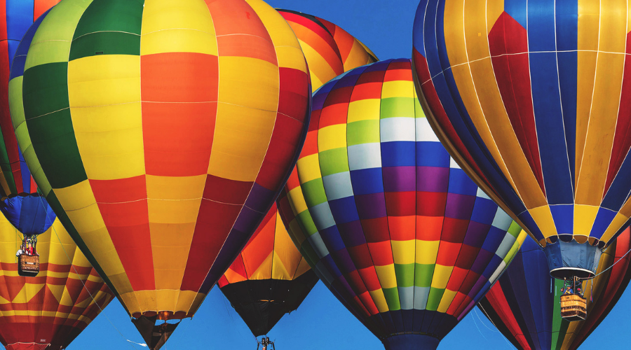 Image shows hot air balloons representing soaring Asheville Real Estate Market